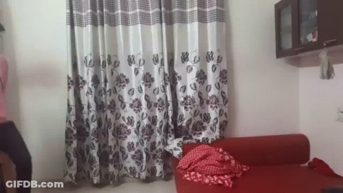 Living Room Red Couch And Floral Curtains GIF