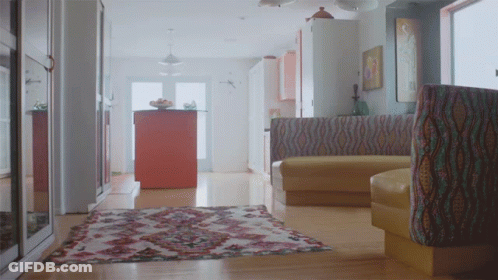 Living Room With Rug And Yellow Couch GIF