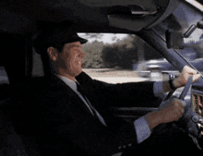 Lloyd Christmas Jim Carrey Driving Car  Got Worms GIF