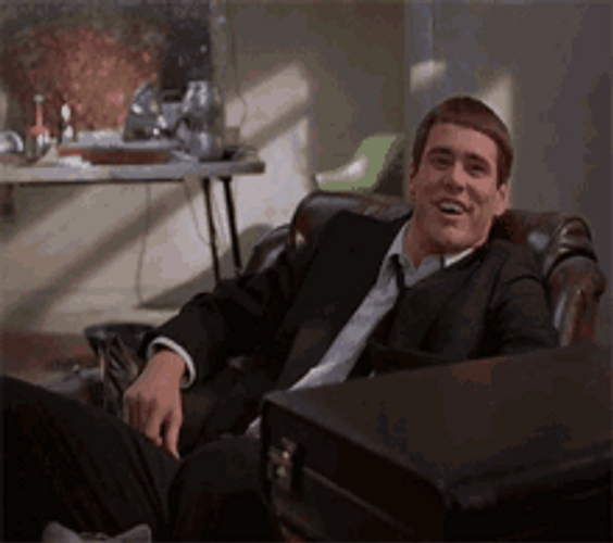 Lloyd Christmas Jim Carrey Laughing Shrug GIF