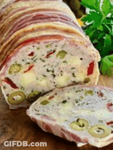 Loaf Of Meat With Olives And Cheese On Cutting Board GIF