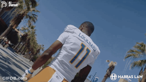 Lockhart Football Player Walking Down Street GIF