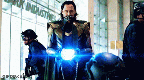 Loki From Avengers : Age Of Ultron Is Standing In Front Of A Building Holding A Light . GIF