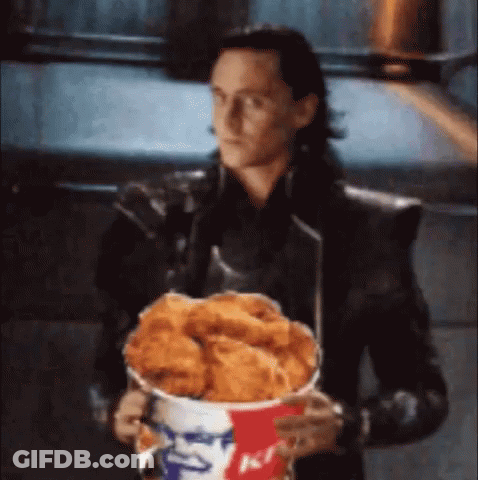 Loki Is Holding A Bucket Of Fried Chicken In His Hands . GIF