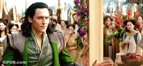 Loki Is Standing In Front Of A Crowd Of People In A Room . GIF