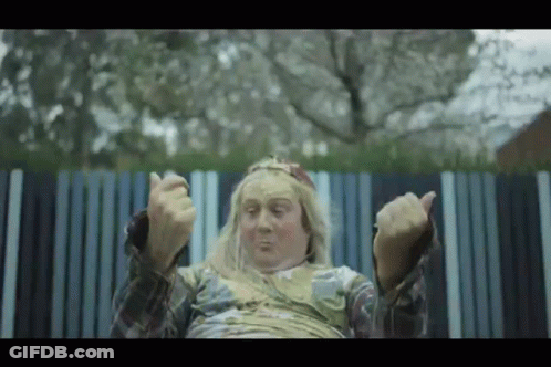 Long Blonde Hair Man Sitting By Striped Fence GIF
