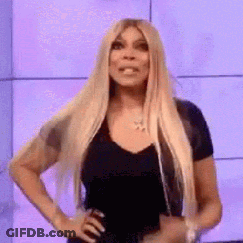 Long Blonde Hair Woman Hands On Hips Looking At Camera GIF