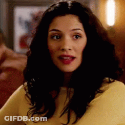 Long Dark Hair Woman In Yellow Shirt Looking GIF
