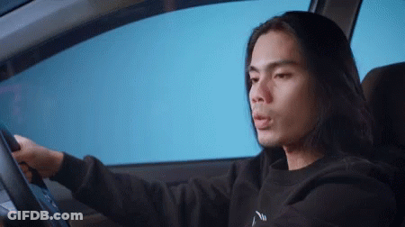 Long Hair Man Driving Car In Black Sweatshirt Saying N GIF
