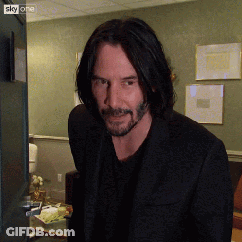 Long-Haired Bearded Man In Front Of Sky One Door GIF