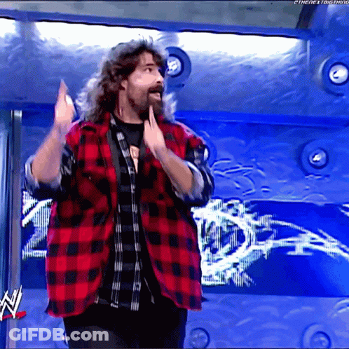 Long Haired Bearded Man In Red And Black Plaid Shirt At WWE Logo GIF