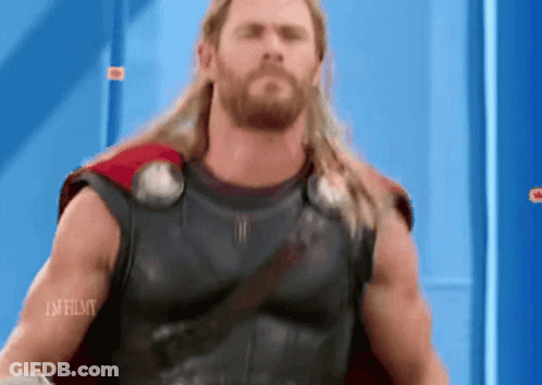 Long Haired Bearded Man In Superhero Costume Blue Wall GIF