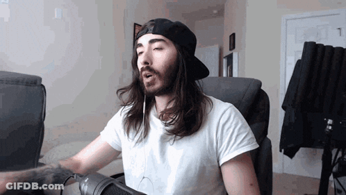 Long Haired Bearded Man Singing Into Microphone With Headphones GIF
