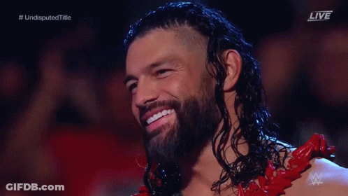 Long Haired Bearded Man Smiling In Red Outfit GIF