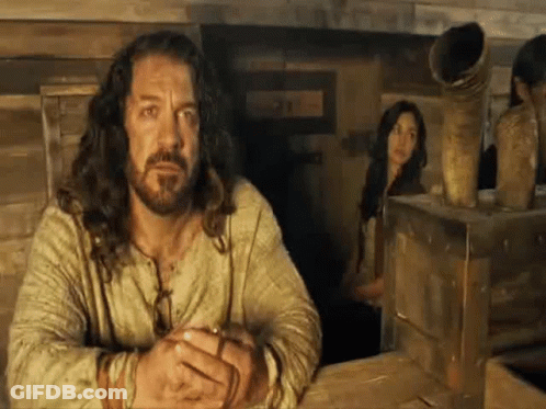 Long Haired Bearded Man With Woman Behind GIF