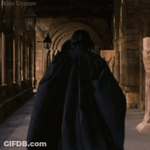 Long-Haired Man Hand On Chin In Dark Room GIF