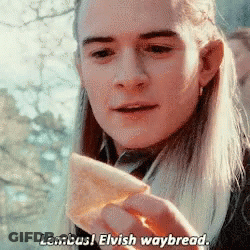 Long-Haired Man Holding Bread Saying Lembas Elvish Waybread GIF