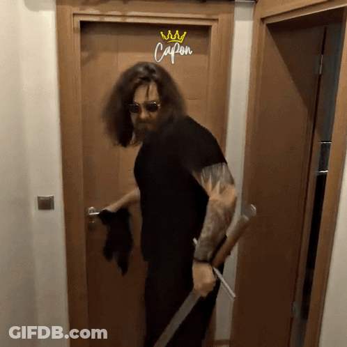 Long Haired Man Holding Sword At Capon Door GIF