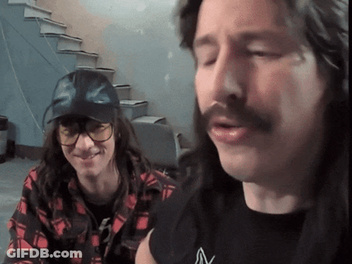 Long-Haired Man In Glasses And Black V Shirt GIF