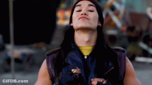Long-Haired Man In Purple Vest And Yellow Shirt GIF