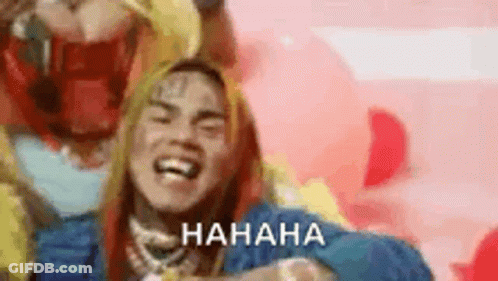 Long Haired Man Laughing In Pink Background Blue Jacket GIF