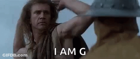 Long Haired Man Next To Man In Helmet Holding Hair GIF