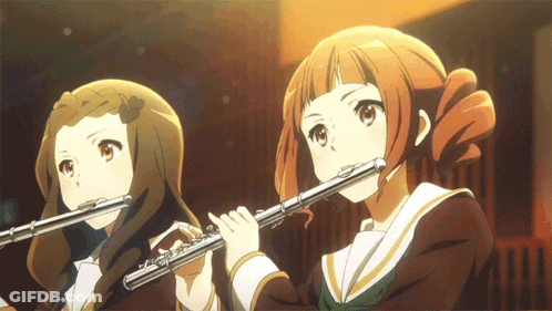 Long-Haired Man Playing Flute Dark Room GIF