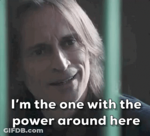 Long-Haired Man Smiling Behind Fence Says I'm The One With The Power Around Here GIF