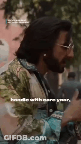 Long-Haired Man With Beard And Sunglasses In Floral Shirt Talking GIF