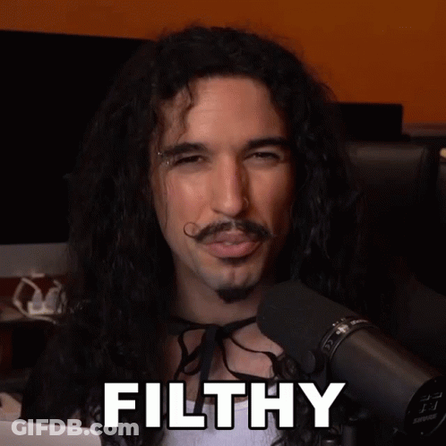 Long Haired Man With Mustache Says Filthy At Microphone GIF