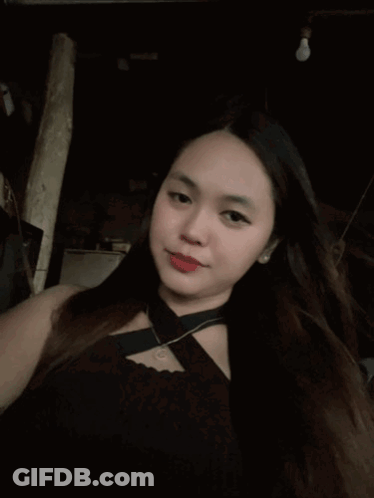 Long-Haired Woman In Black Top And Necklace GIF
