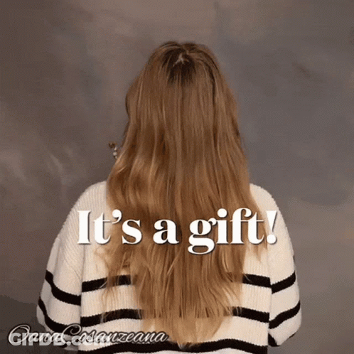 Long Haired Woman In Striped Sweater Saying It's A Gift GIF