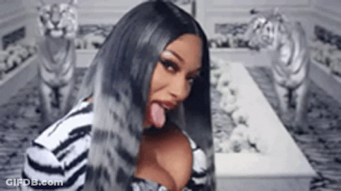 Long-Haired Woman Sticking Tongue Out At Tiger Statues GIF
