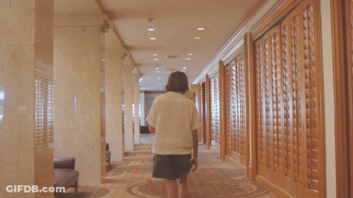 Long Hallway With Balloons On Floor And Chandelier GIF