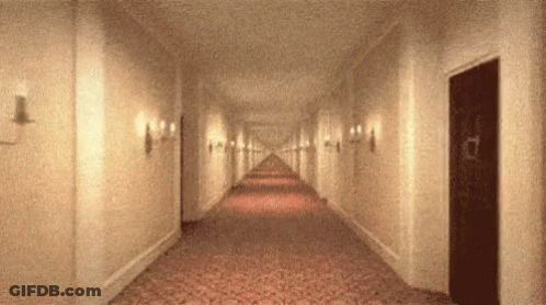 Long Hallway With Door In Middle GIF