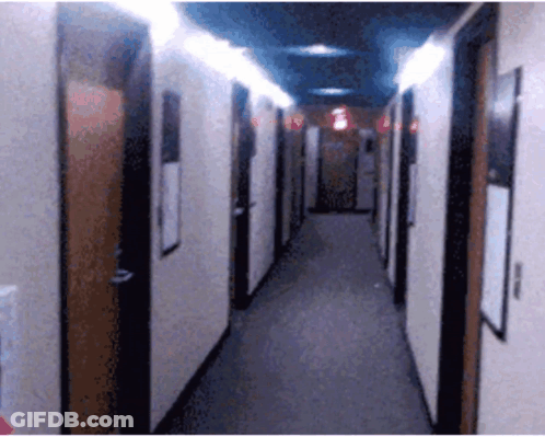Long Hallway With Red Exit Sign GIF