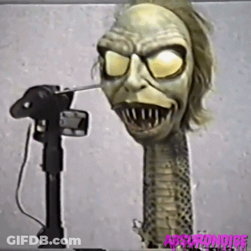 Long-Necked Monster Statue Being Photographed GIF
