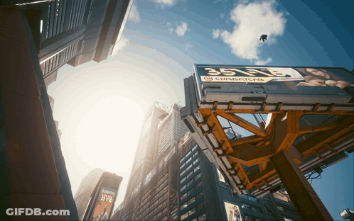 Looking Up At A City Skyline With A Billboard That Says Condoms On It GIF