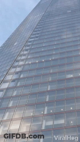 Looking Up At A Tall Building With Viralhog Written On The Bottom Right GIF