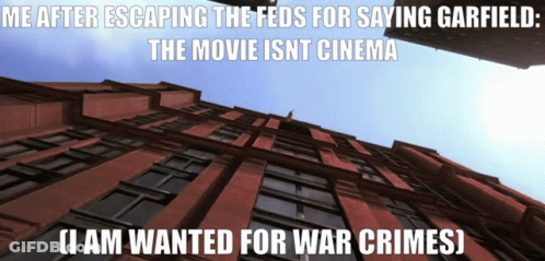 Looking Up At Brick Building Saying Me After Escaping The Feds For Saying Garfield The Movie Isn't Cinema GIF