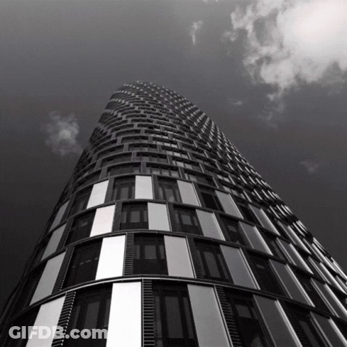 Looking Up At Tall Building With Cloudy Sky GIF