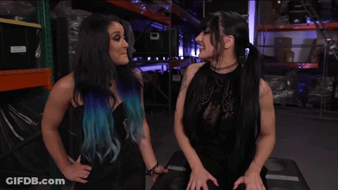 Lyra Valkyria And Tatum Paxley Are Standing Next To Each Other In A Warehouse GIF