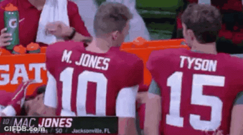 Mac Jones And Tyson Sitting In Stands GIF
