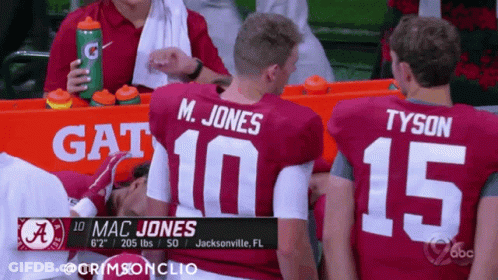 Mac Jones And Tyson Sitting On Sidelines GIF