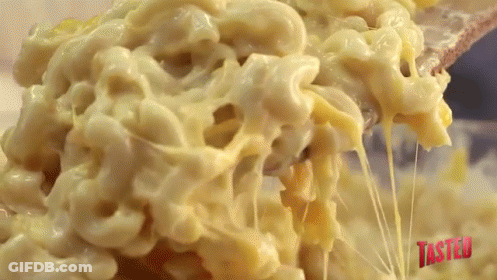 Macaroni And Cheese Is Being Scooped Out Of A Bowl GIF