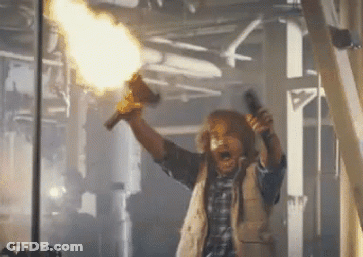 Macgruber Holding Gun While Shooting GIF