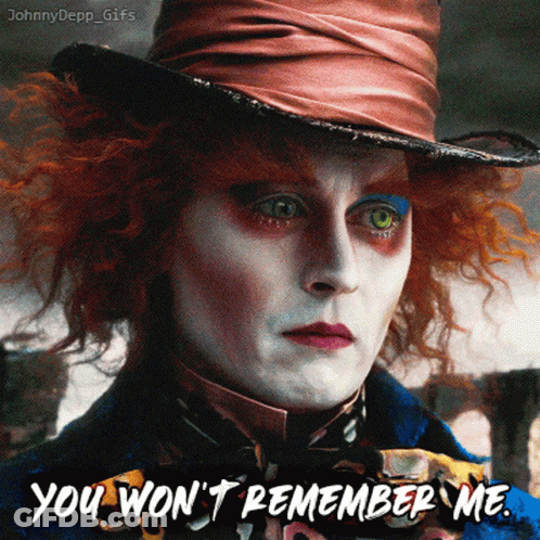 Mad Hatter Blowing Out Candle On Pink Cake GIF