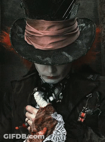 Mad Hatter Wearing Hat And Scarf Holding Meat GIF