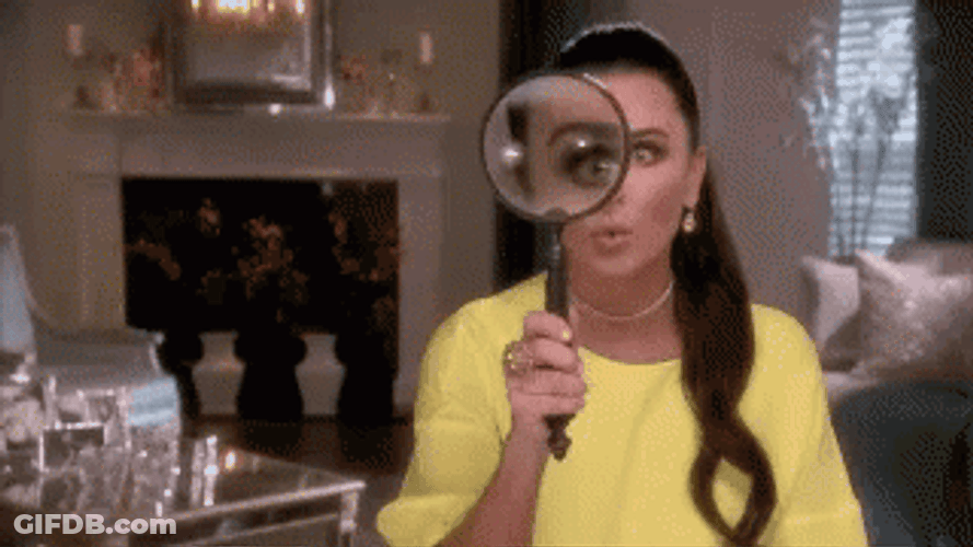 Magnifying Glass Amazes Yellow Lady GIF