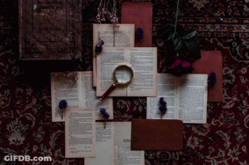 Magnifying Glass On Books Saying Agatha Christie GIF
